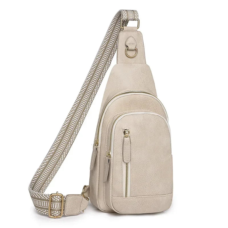 Sac à bandoulière beige clair en cuir PU, avec double zip et sangle textile graphique, présenté sur fond blanc pour une vue produit détaillée.