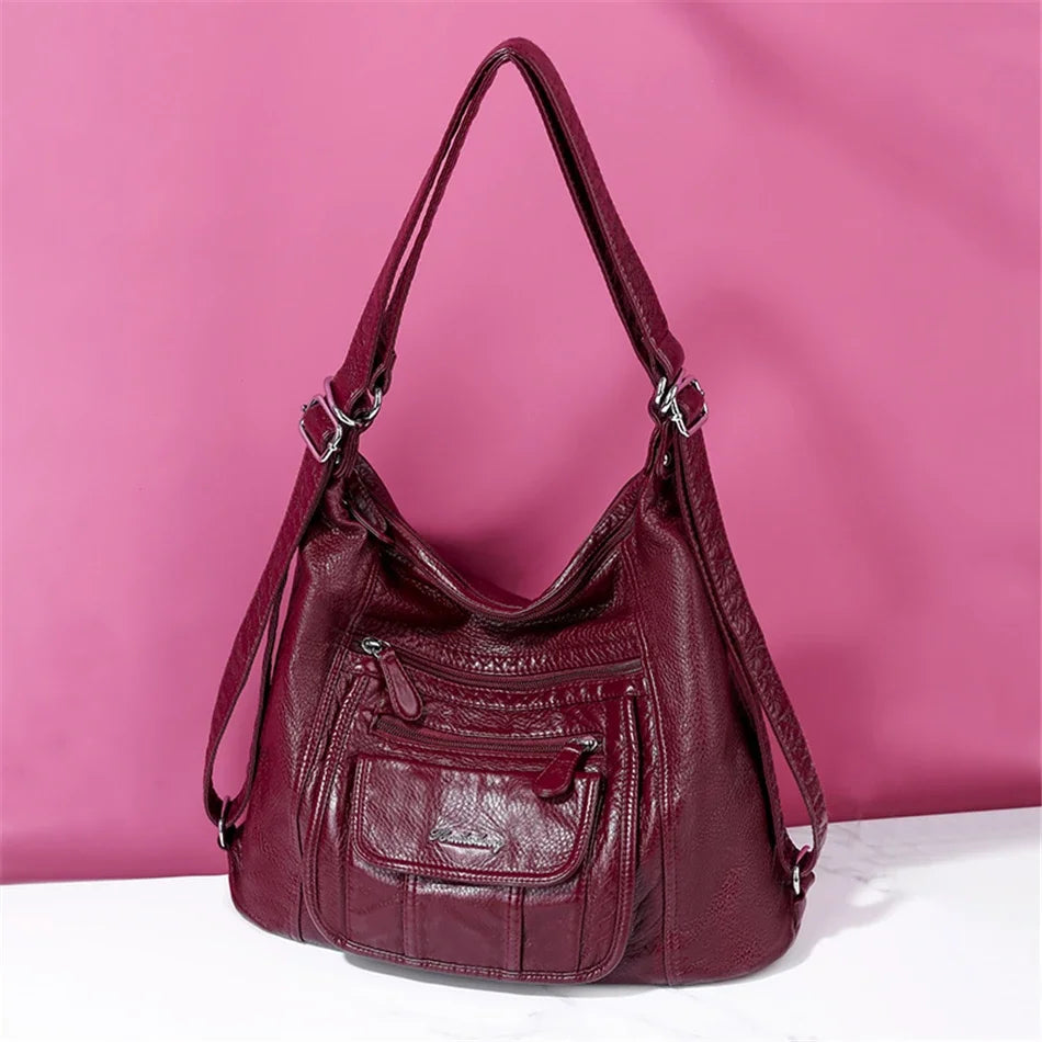 Sac à main en cuir bordeaux de la marque Vanderwah avec poches zippées et bandoulière ajustable.