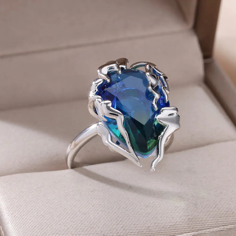 ague en forme de flamme avec zircon bleu – Monture argentée élégante.